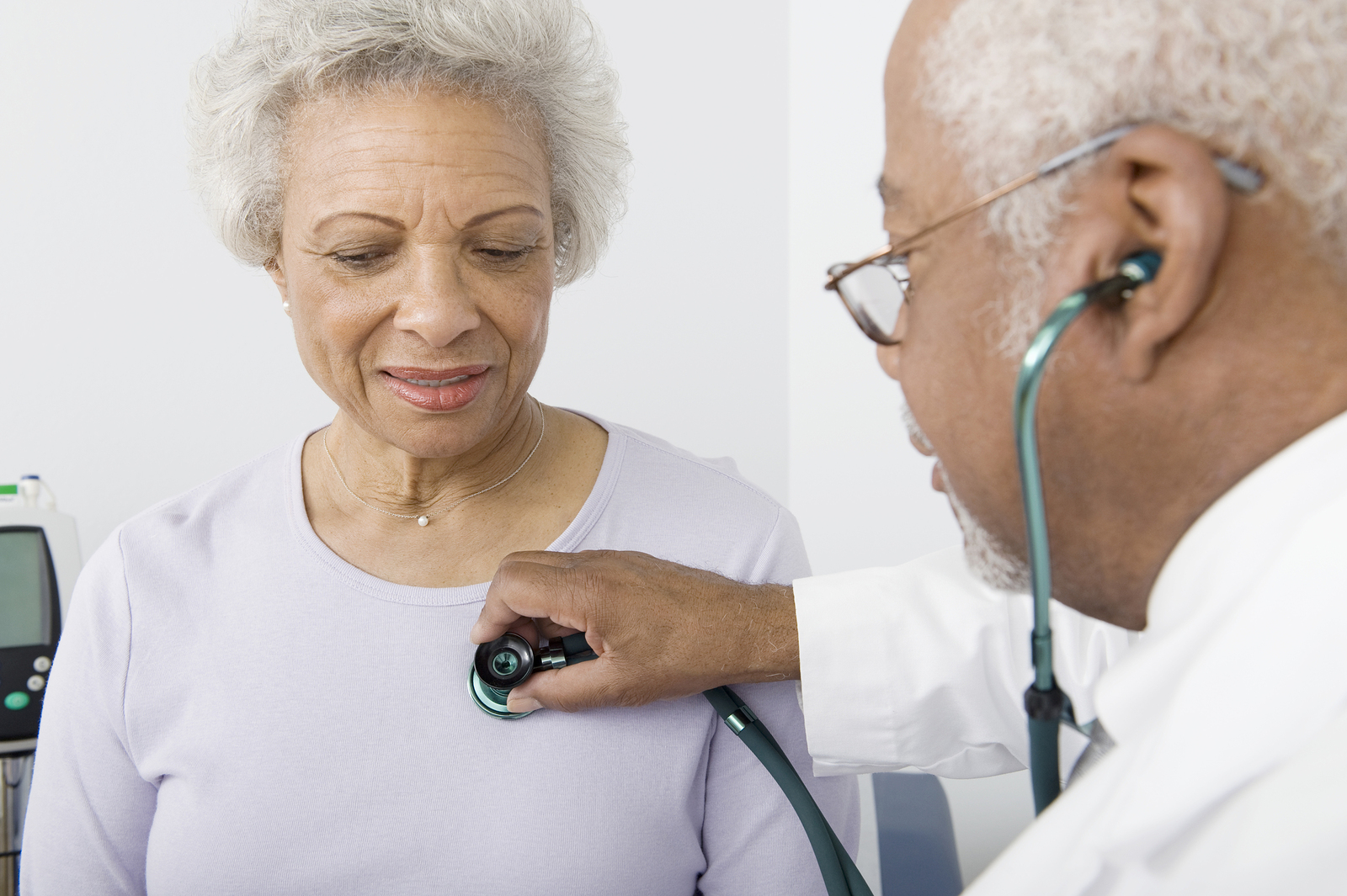 African American doctor checking patient using stethoscope