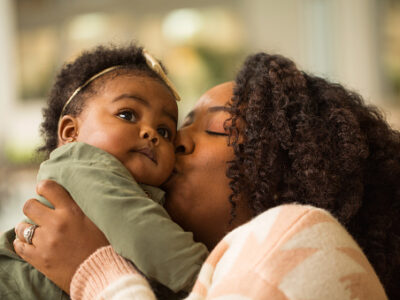 Black mom and daughter playing.