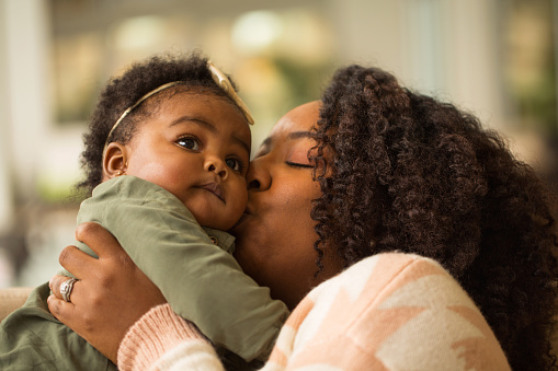 Black mom and daughter playing.